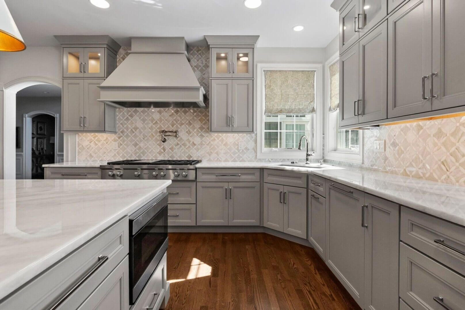 Modern kitchen with gray cabinets and island.