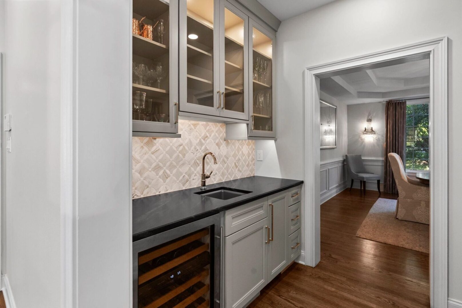 Modern kitchen with cabinets and dining room.