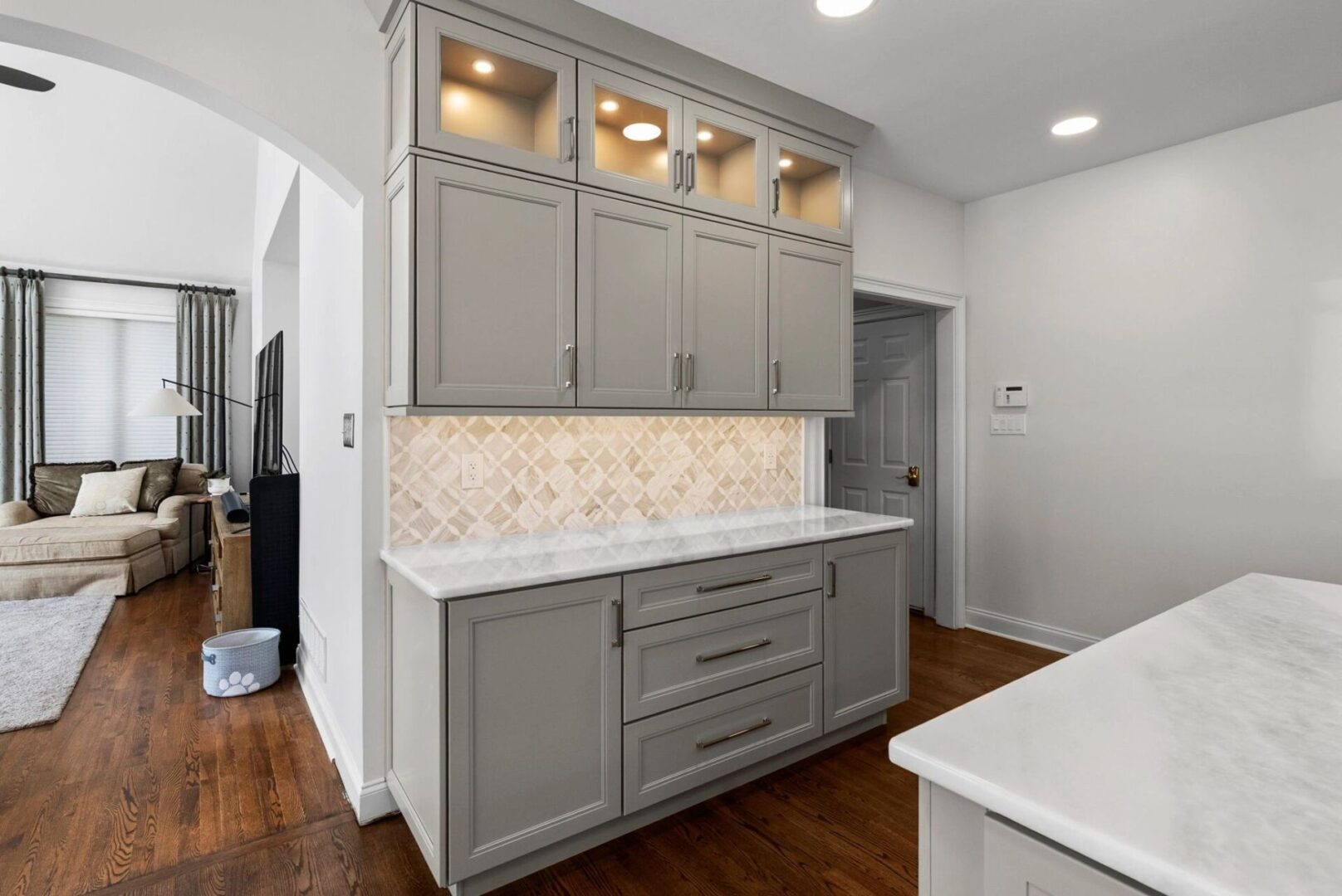 Modern kitchen with gray cabinets and countertop.