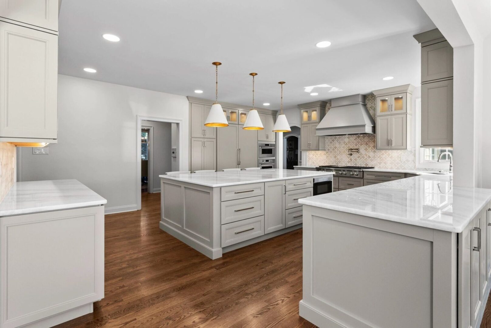 Modern kitchen with white cabinets and island.