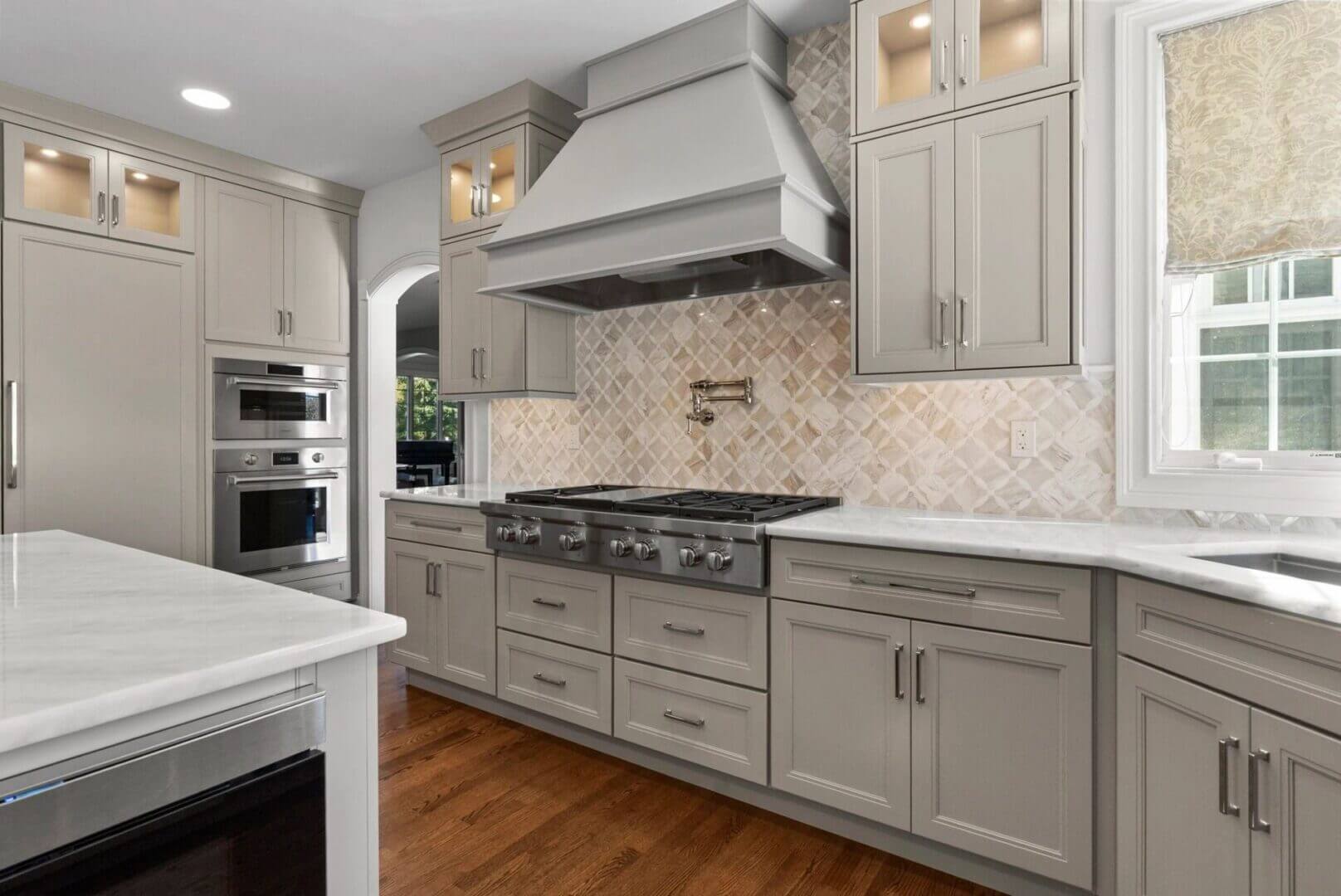 Modern kitchen with gray cabinets and appliances.