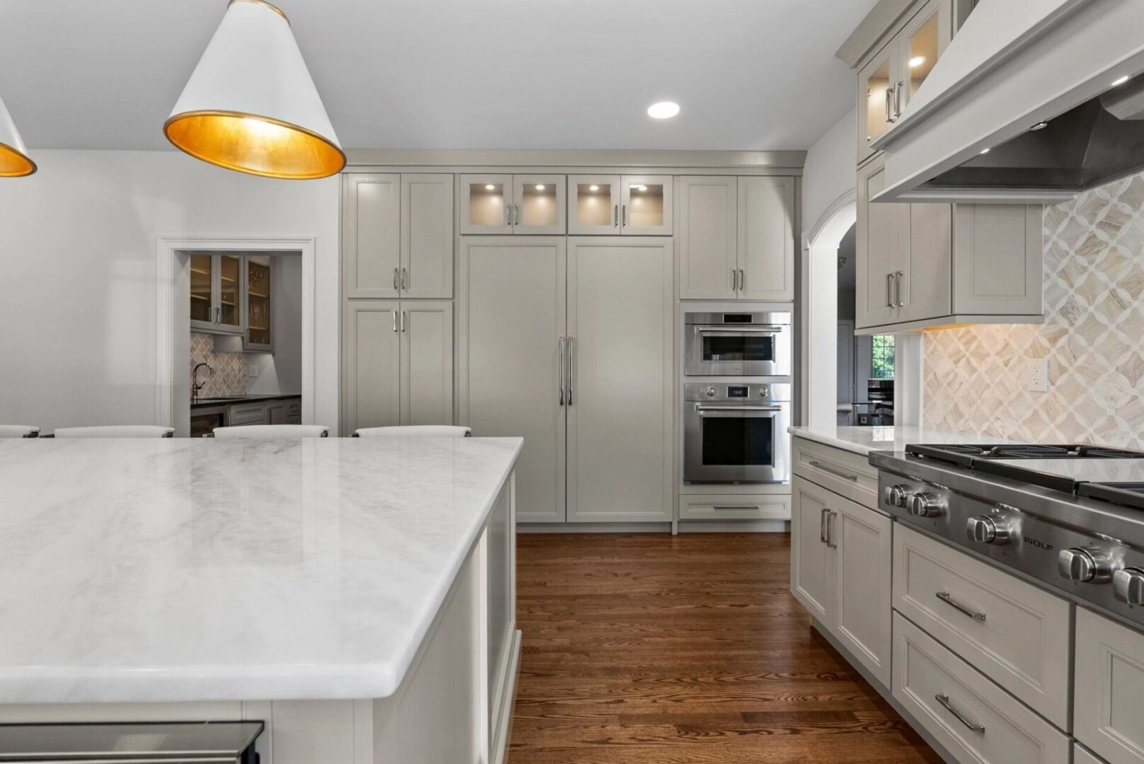 Modern kitchen with marble island countertop.