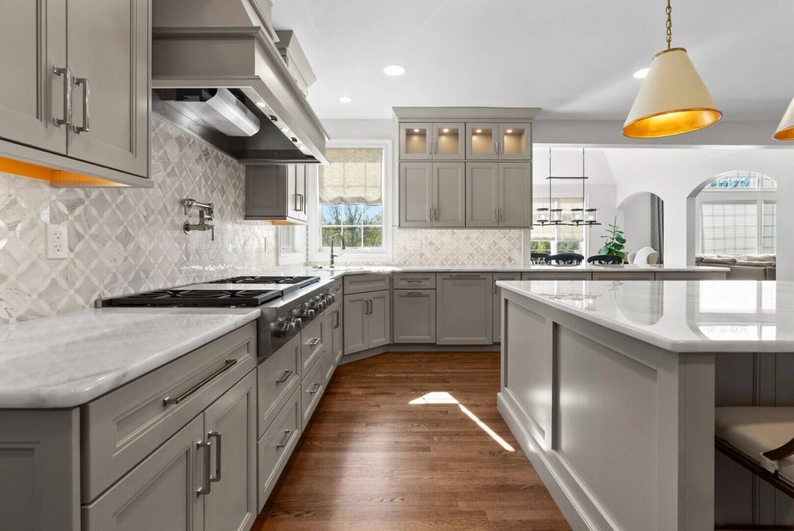 Modern kitchen with gray cabinets and island.