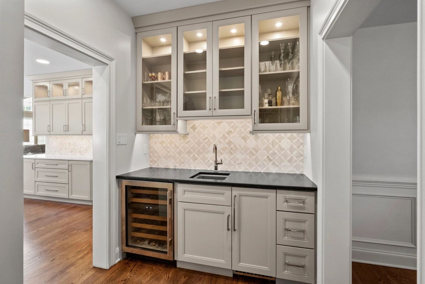 Modern kitchen with glass cabinets and sink.