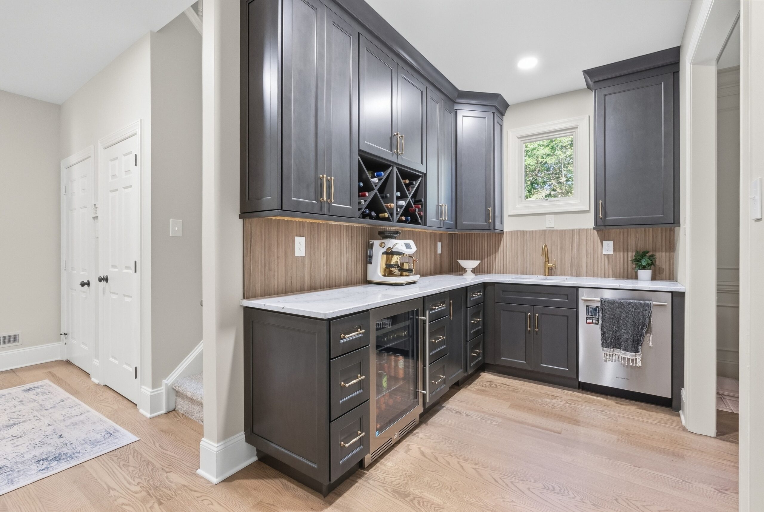 Butler's pantry featuring walnut cabinets and stanless steel appliances.