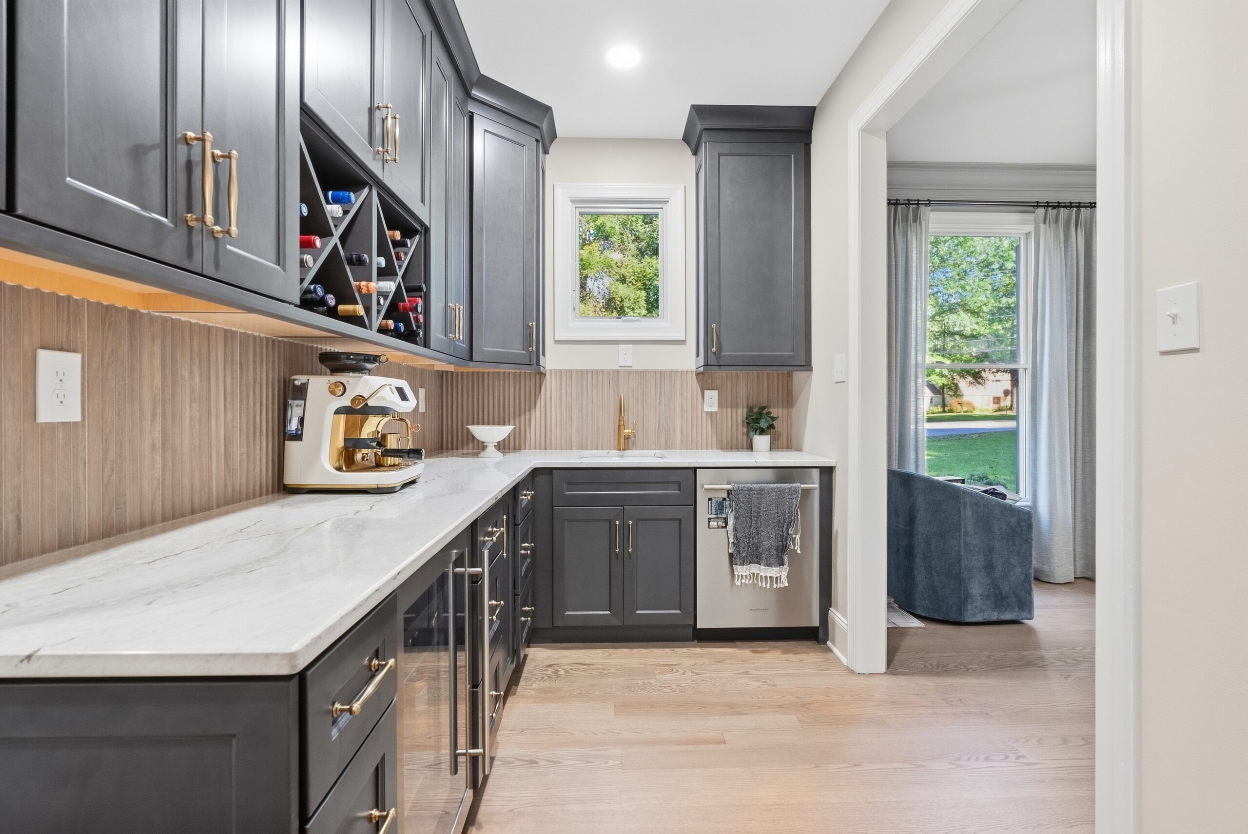 Butler's pantry featuring walnut cabinets and stanless steel appliances.