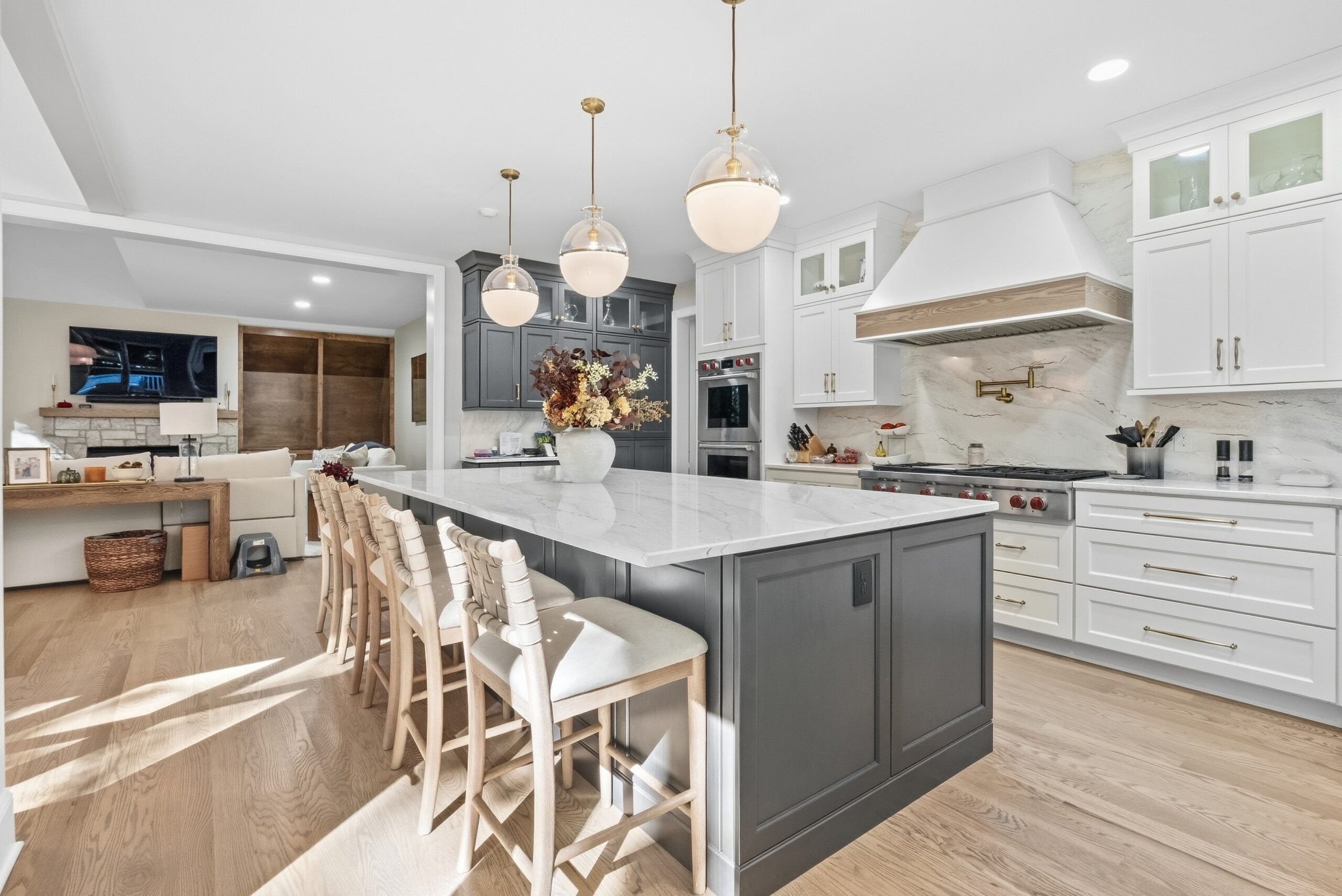 New kitchen installation completed by Reaction Exteriors featuring white cabinets, high end applianced and gold fixtures.