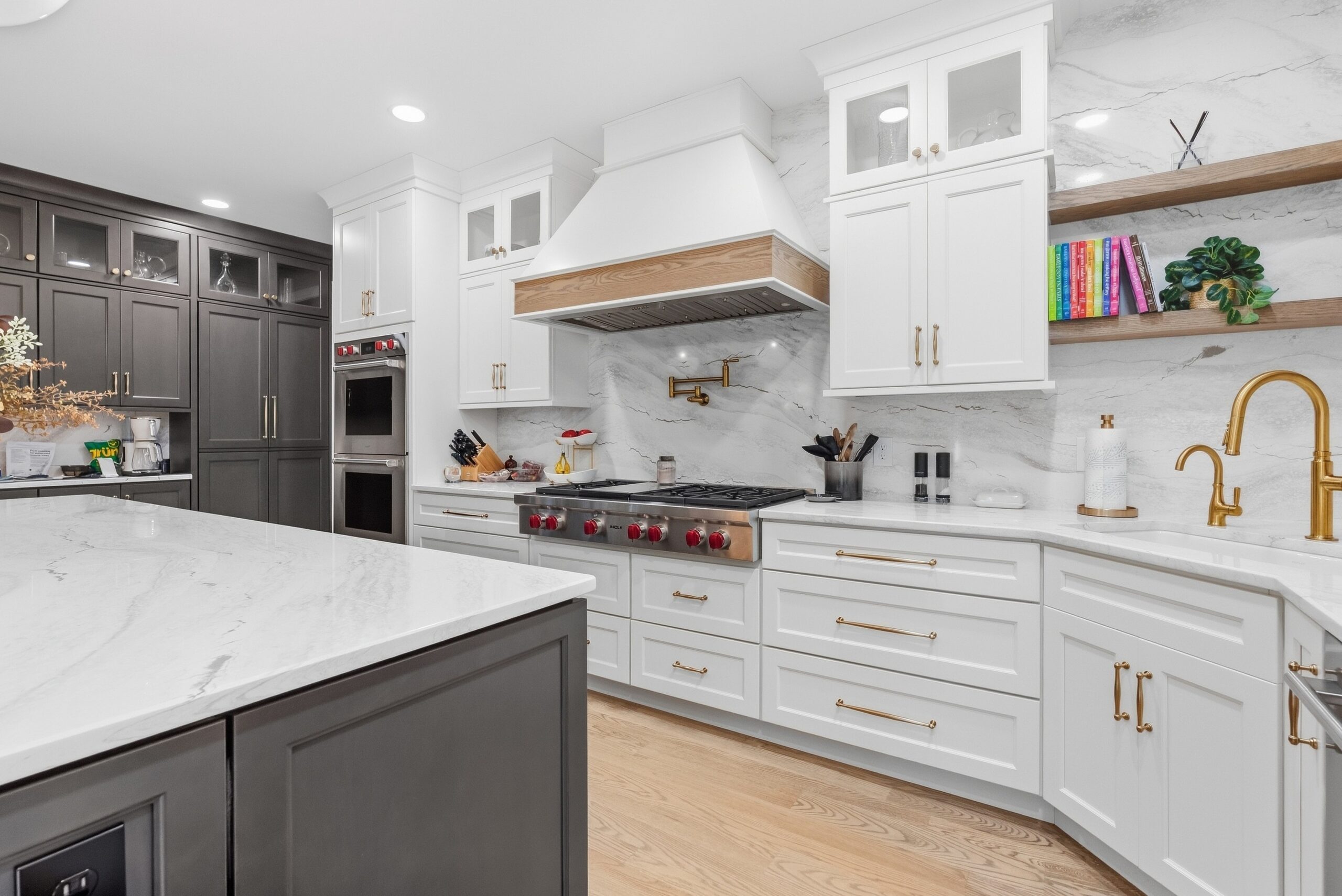 Modern kitchen featuring white cabinets and high end appliances